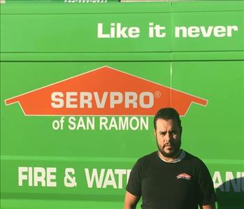 Sergio in front of SERVPRO truck